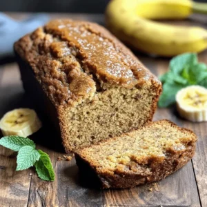 Freshly baked banana bread without butter, sliced on a rustic wooden table with ripe bananas in the background